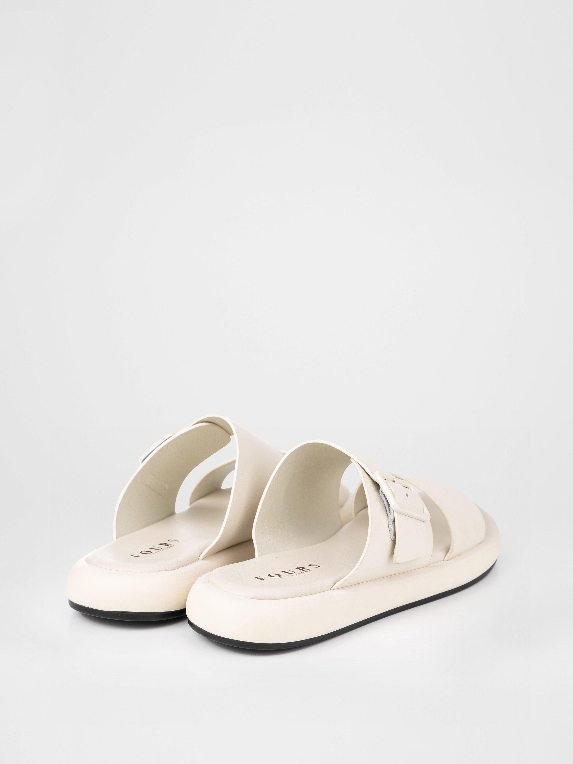 Cream-colored clogs decorated with a buckle