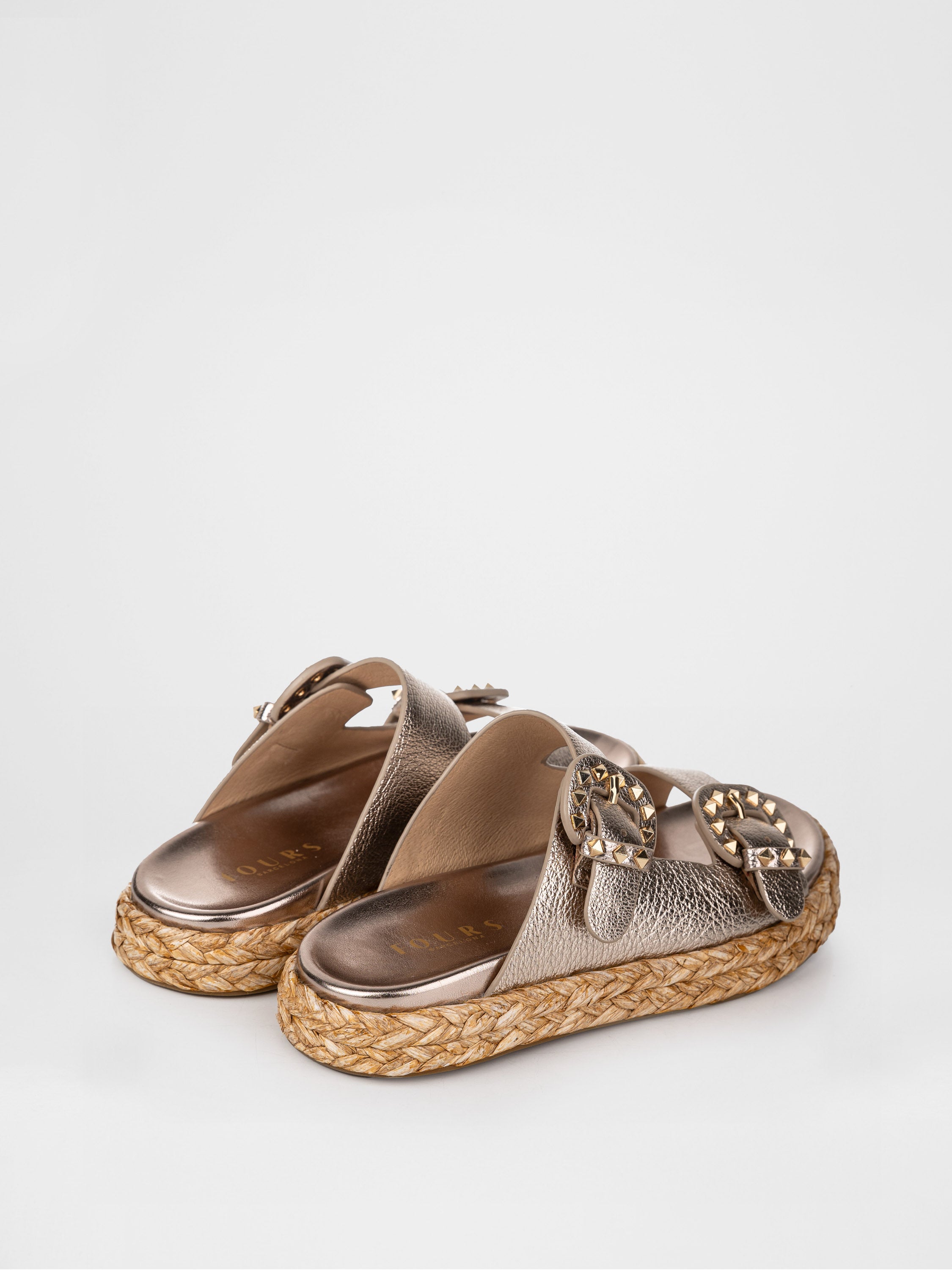 Gold-colored clogs decorated with buckles