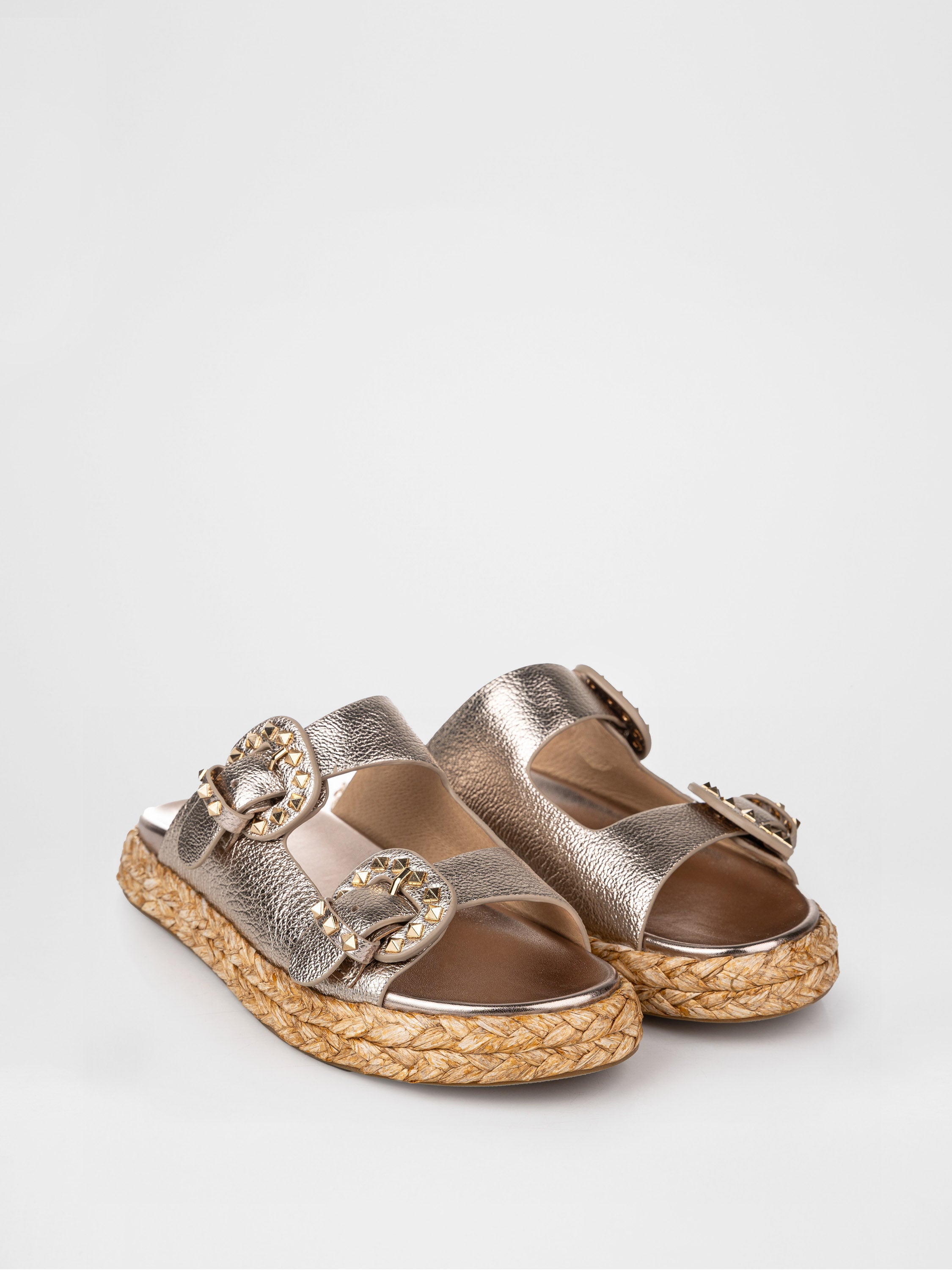 Gold-colored clogs decorated with buckles
