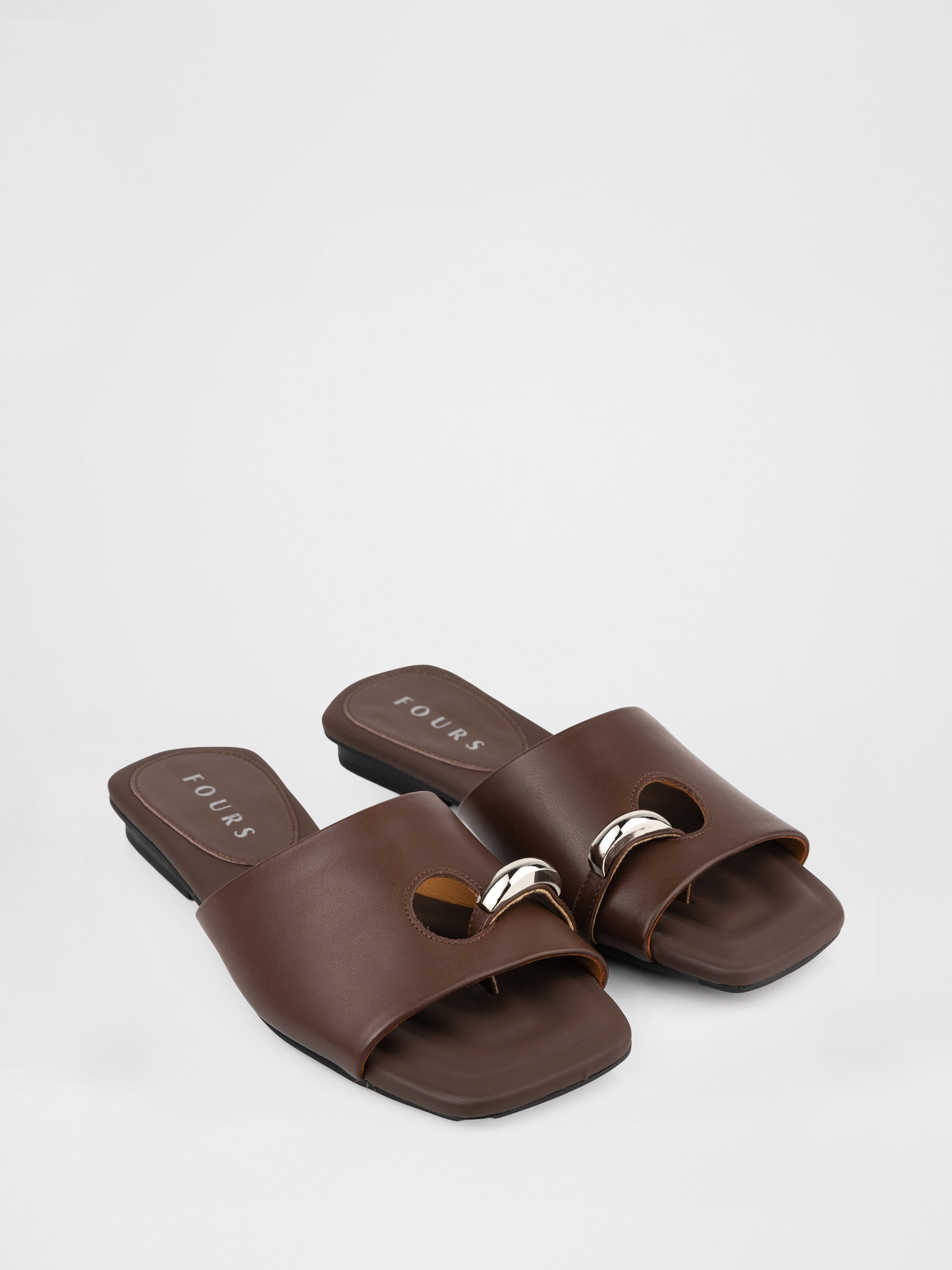 Genuine leather clogs with a decorative metal insert