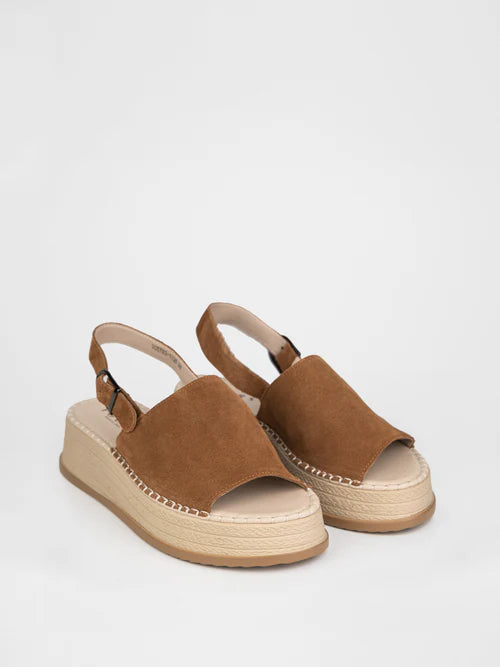 Sandalias en color marrón sobre plataforma de mimbre.
