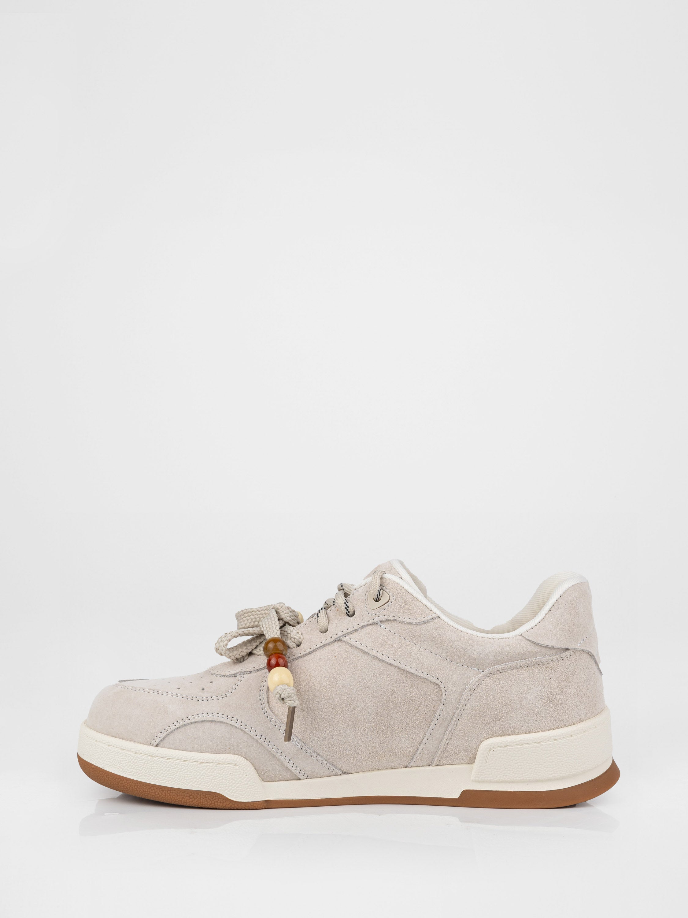 Beige sneakers with decorative details